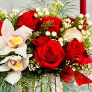 ed and White Holiday Bowl features roses, orchids, and greens in a gold vase. Same-day Los Angeles flower delivery by Beverly Hills Florist.