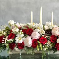 Elegant holiday centerpiece featuring red roses, white tulips, peonies, and berries in a chic arrangement for same-day delivery in Beverly Hills, CA.