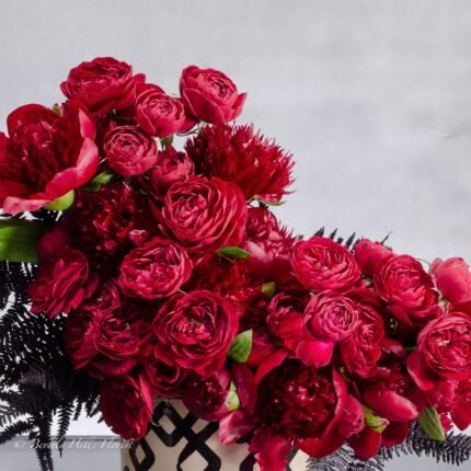 Peony Romance - beverlyhillsfloristPeony Romance floral arrangement with red garden spray roses and burgundy peonies in a ceramic vase, 18 inches tall, available for same-day delivery by Beverly Hills Florist.